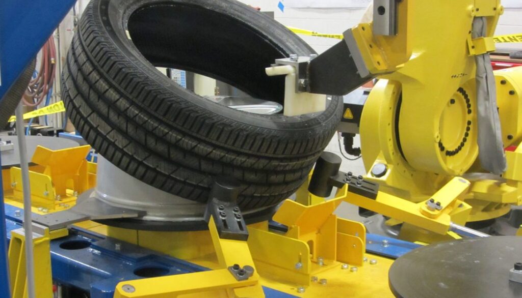A robot is working on a tire in a factory.