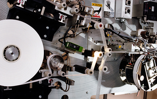A machine with a lot of white paper on it.