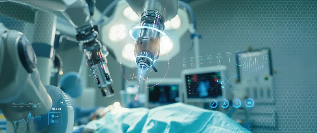Close-up of robotic surgical instruments operating on a patient in an advanced surgical room. Monitors display various medical data.