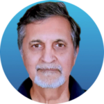 Portrait of an older man with gray hair, a short gray beard and mustache, wearing a dark shirt, shown against a blue gradient background.