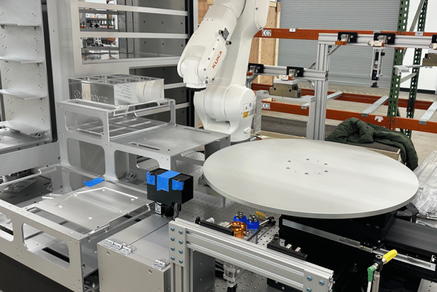 Industrial robotic arm in a factory setting engaged in material handling automation.
